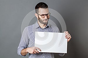 Displeased young businessman claiming on protest sign