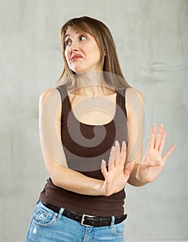 Displeased young girl gesturing in studio