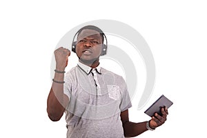 Displeased young man listening to music with headphones on a digital tablet