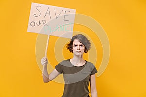 Displeased young protesting woman hold protest sign broadsheet placard on stick isolated on yellow background studio