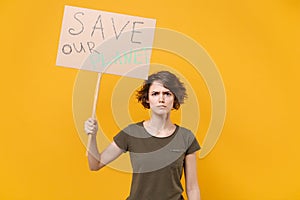 Displeased young protesting woman hold protest sign broadsheet placard on stick isolated on yellow background studio photo