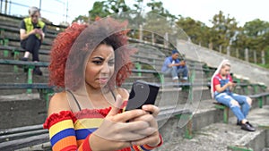 Displeased young woman watching cruel video online smartphone, internet content