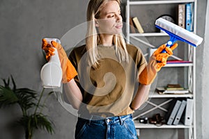 Displeasure woman posing with streak and cleaning spray at home