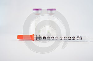 Dispoable syringe and Purple cap of medicine injection vial