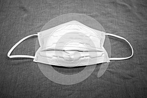 Disposable anti pollutant face mask with comfort strap isolated on grey