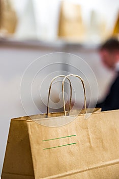 Disposable bag of kraft paper on a blurred background.