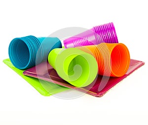 Disposable bright plastic cups and plates stacked