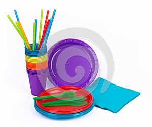 Disposable bright plastic kitchenware stacked on white
