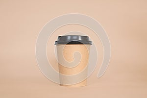 Disposable coffee cup on a brown background