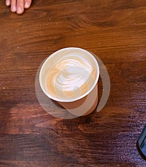 Disposable cup with cream coffee to go
