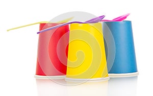 Disposable cups and spoons isolated on white