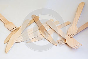 Disposable eco friendly wooden forks and knifes on white background. Eco friendly disposable wooden cutlery on white background