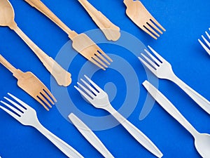 Disposable ecological wooden bamboo and biodegradable plastic fork and spoon pattern on a trendy blue background. Environment