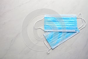 Disposable face mask on light background photo