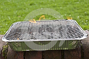 Disposable foil BBQ. Selective focus