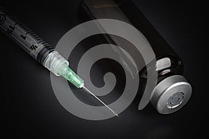 Disposable Injection And Amber Color Vial On Black Background