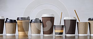 Disposable paper coffee cups in different colors and designs