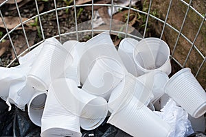 Disposable plastic cups on open container