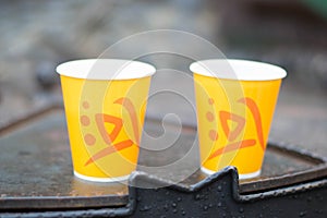 Disposable plastic cups of orange color