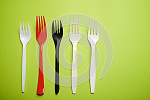 Disposable plastic forks on a green table