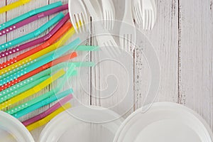 Disposable plastic plates,forks and straws. Top view, copy space. Plastic free concept. Single-use plastic, evironmental