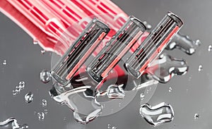 Disposable shaving machine for women on wet mirror background