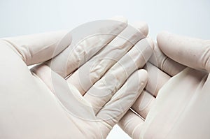 Disposable sterile white gloves on white background