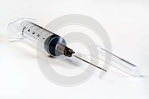Disposable syringe. Plastic insulin syringe. The insulin syringe with the lid open shows sharp needles. Injection medicine. photo