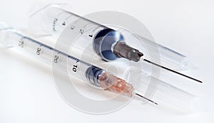 Disposable syringe. Plastic insulin syringe. The insulin syringe with the lid open shows sharp needles. Injection medicine. photo