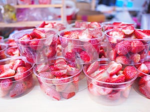 Cup of sliced strawberry preparing for juice or smoothie