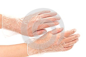 Disposable vinyl gloves on hands close up