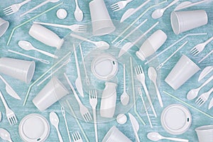 Disposable white single use plastic objects such as bottles, cups, forks and spoons