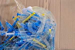 Disposal of medical waste used disposable syringes lie in a large pile