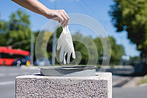 disposing of protective glove in public park bin