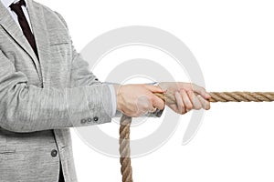 Dispute concept. Businessman pulling rope on white background, closeup