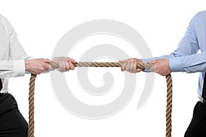 Dispute concept. Men pulling rope on white background, closeup