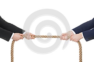 Dispute concept. Men pulling rope on white background, closeup