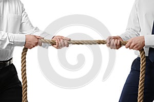 Dispute concept. Men pulling rope on white background, closeup