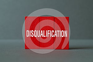 Disqualification - - word concept on building blocks, text photo
