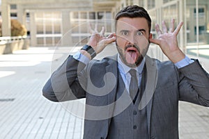 Disrespectful businessman sticking tongue out photo