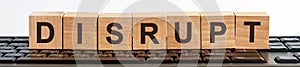 DISRUPT word made with building blocks jn the black keyboard