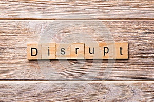 DISRUPT word written on wood block. DISRUPT text on wooden table for your desing, concept