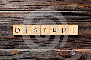DISRUPT word written on wood block. DISRUPT text on wooden table for your desing, concept