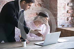 Dissatisfied boss and tired woman in the office