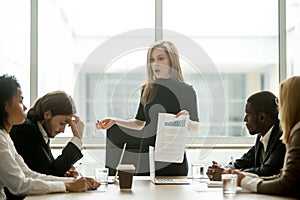 Dissatisfied female executive scolding employees for bad work at