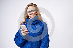 Dissatisfied girl with a mobile phone in hand