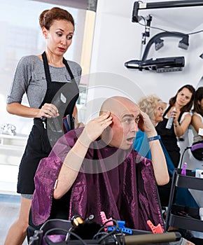 Dissatisfied male client in hair salon