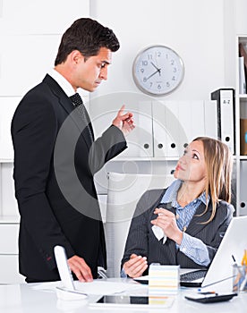 Dissatisfied manager scolding assistant