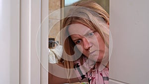 Dissatisfied woman, angry mother opens bathroom door, intimidates at children
