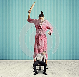 Dissatisfied woman with rolling pin